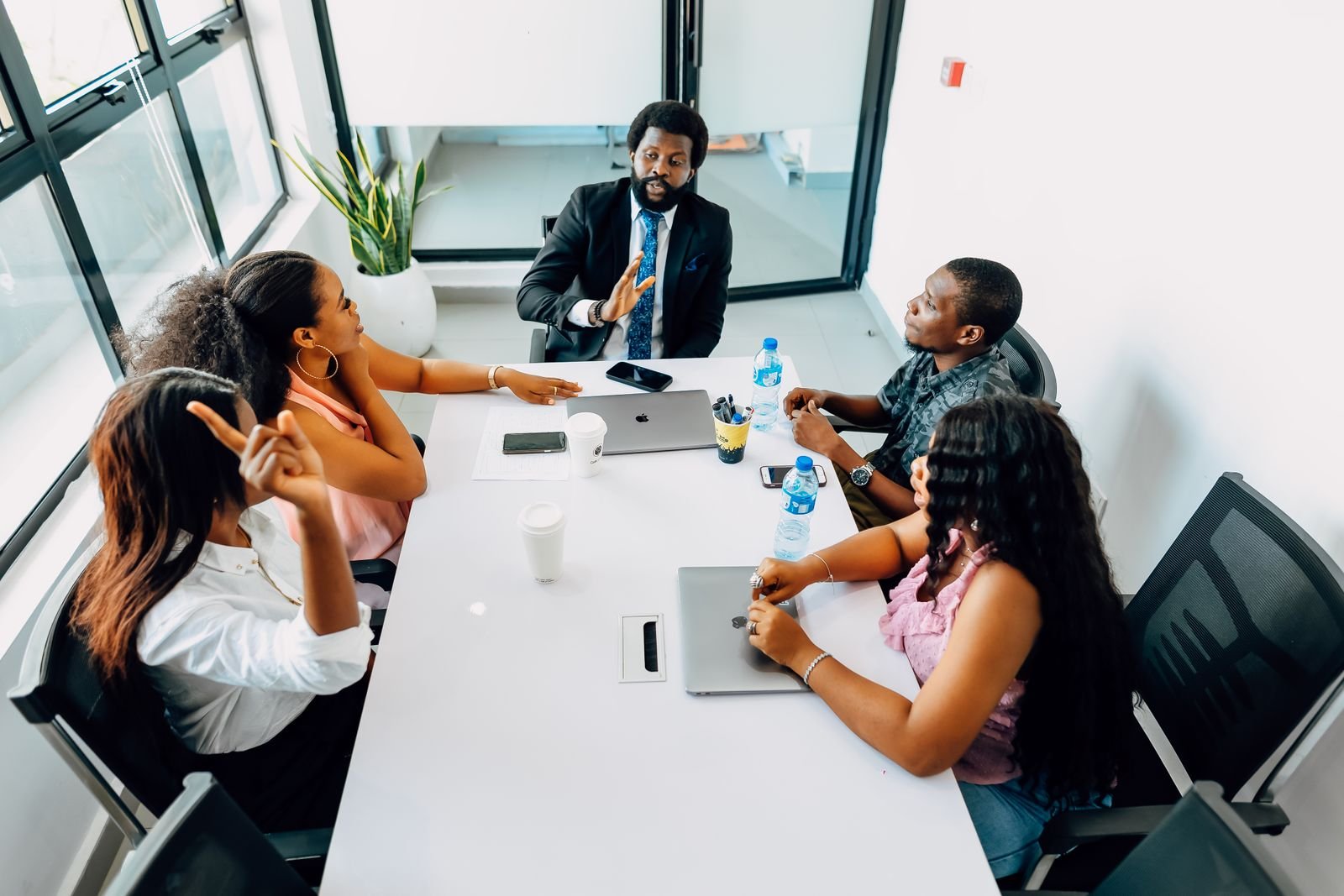 Nigerian marketing team in a Lagos office weighing strategy decisions, representing the AI tools vs human marketers debate