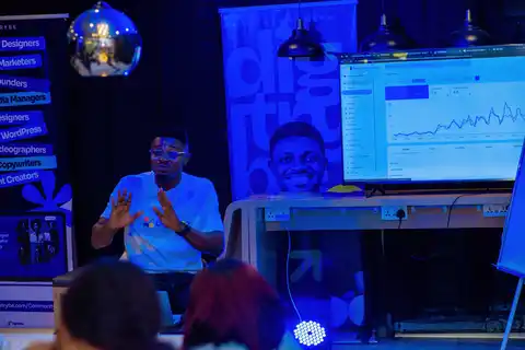 digiTrybe community member presenting search and ad performance data on screen, representing Meta's new ad attribution rules for Nigerian marketers