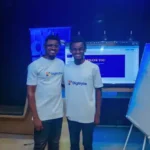 Two young Nigerian professionals in digiTrybe shirts at a training session, representing the path from another career into tech through digital marketing