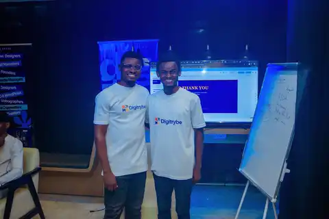Two young Nigerian professionals in digiTrybe shirts at a training session, representing the path from another career into tech through digital marketing